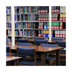 Shelves of books and tables in a library