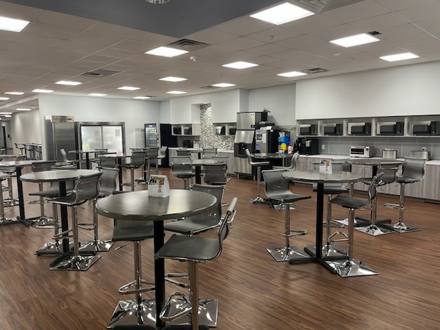 Kitchen prep space with coffee machine and commercial cooler