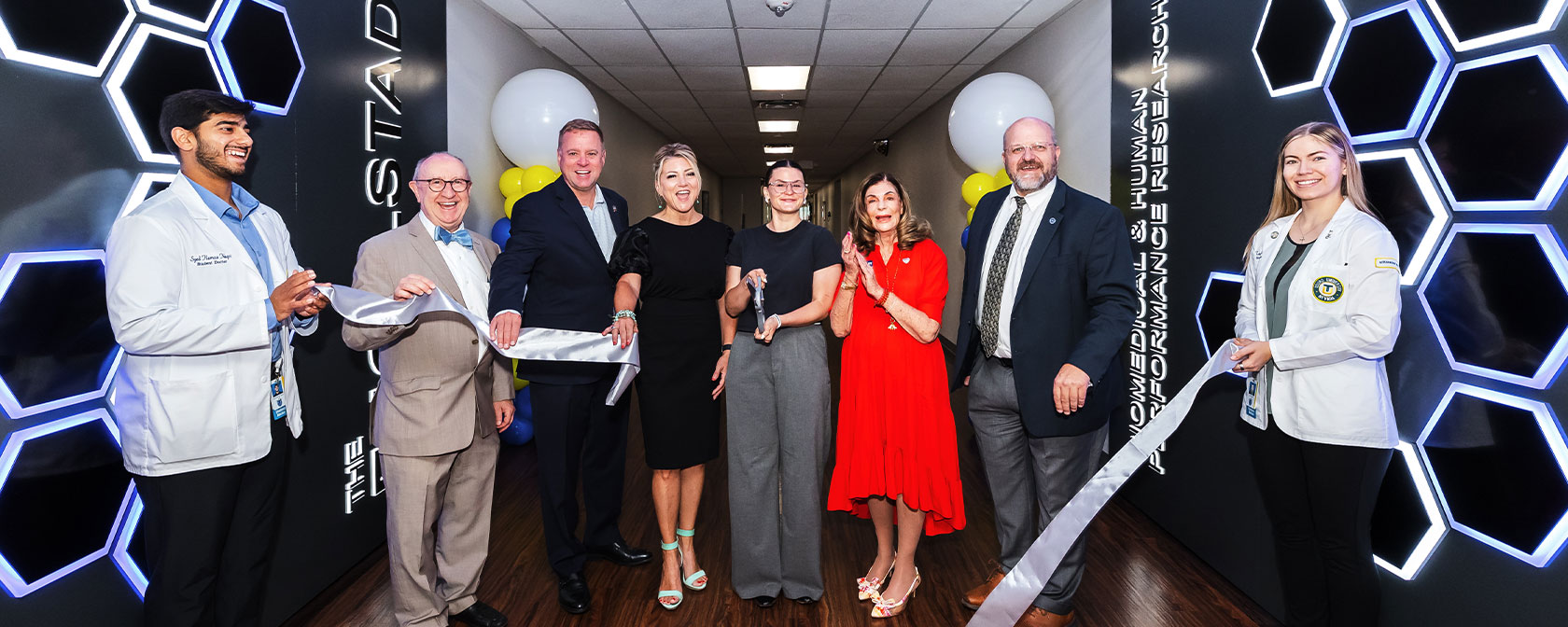 Representatives from Engelstad and Touro Nevada cut the ribbon beneath the new Engelstad Research Complex sign at the grand opening ceremony.