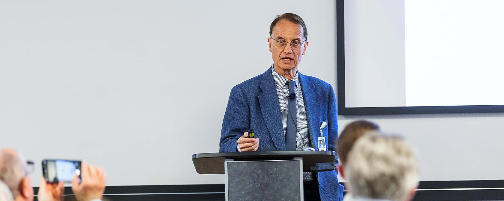 Dr. Aurelio Lorico presents at the podium during Research Day 2023