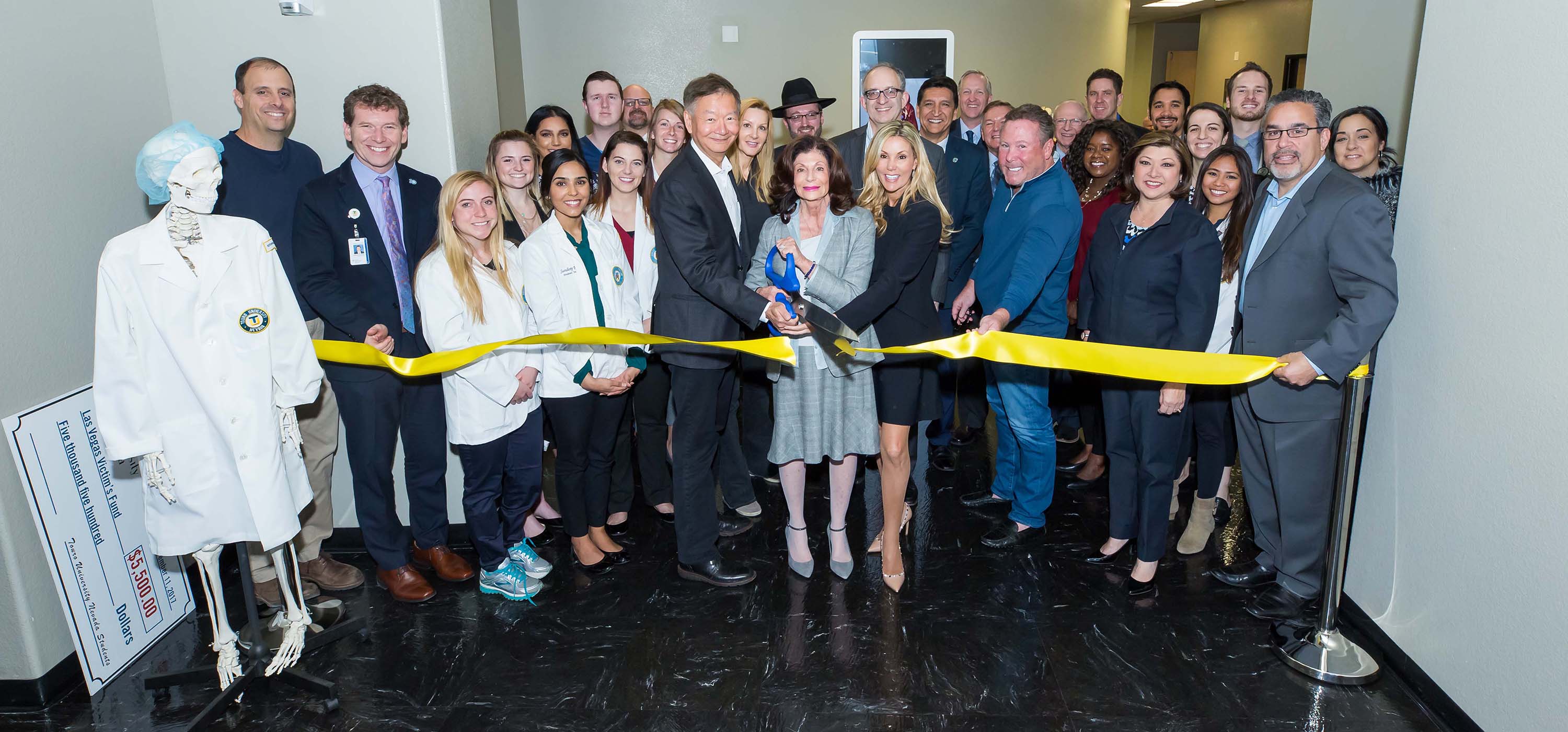 Shelley Berkley cutting the ribbon for a grand opening ceremony.