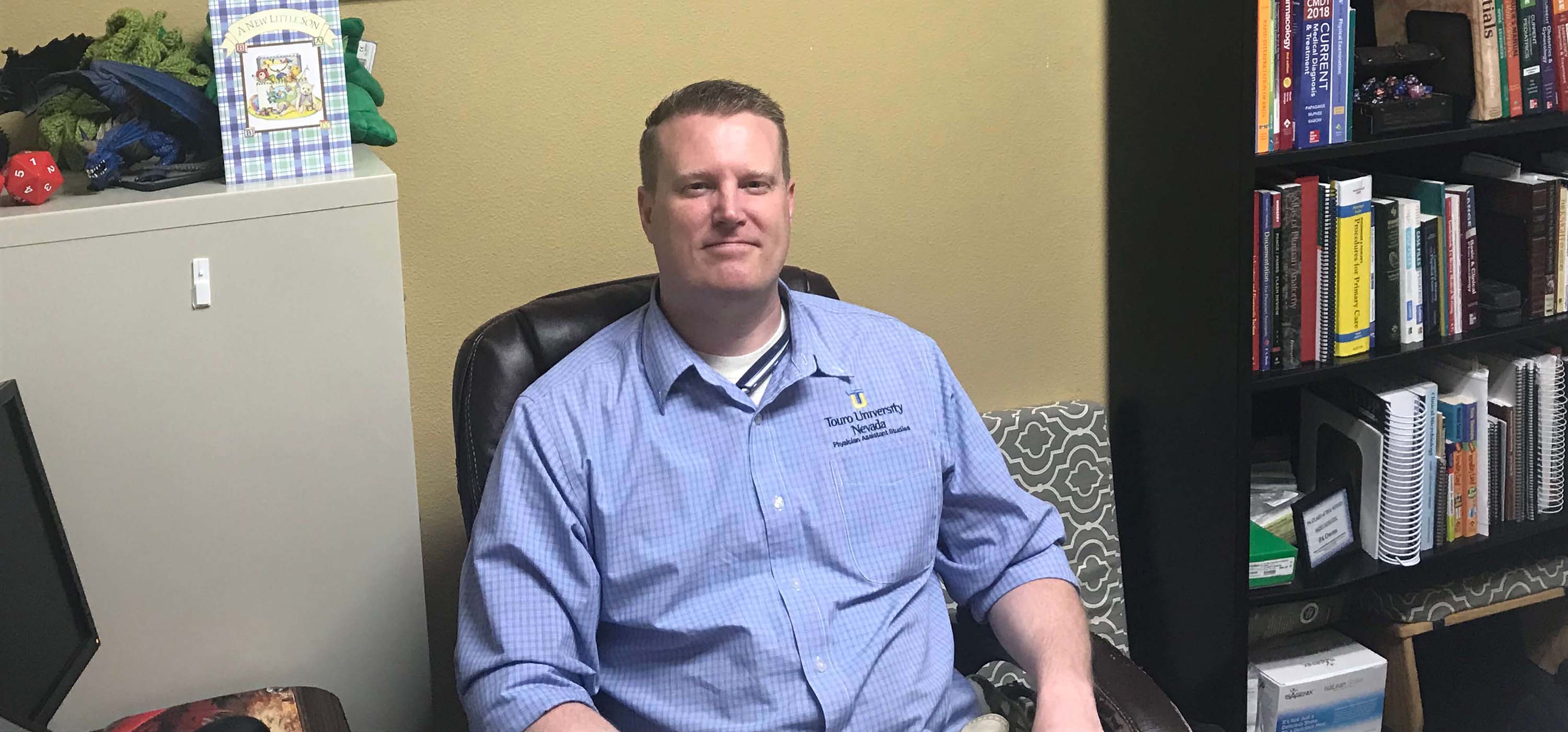 Joshua Owens sitting in his office.