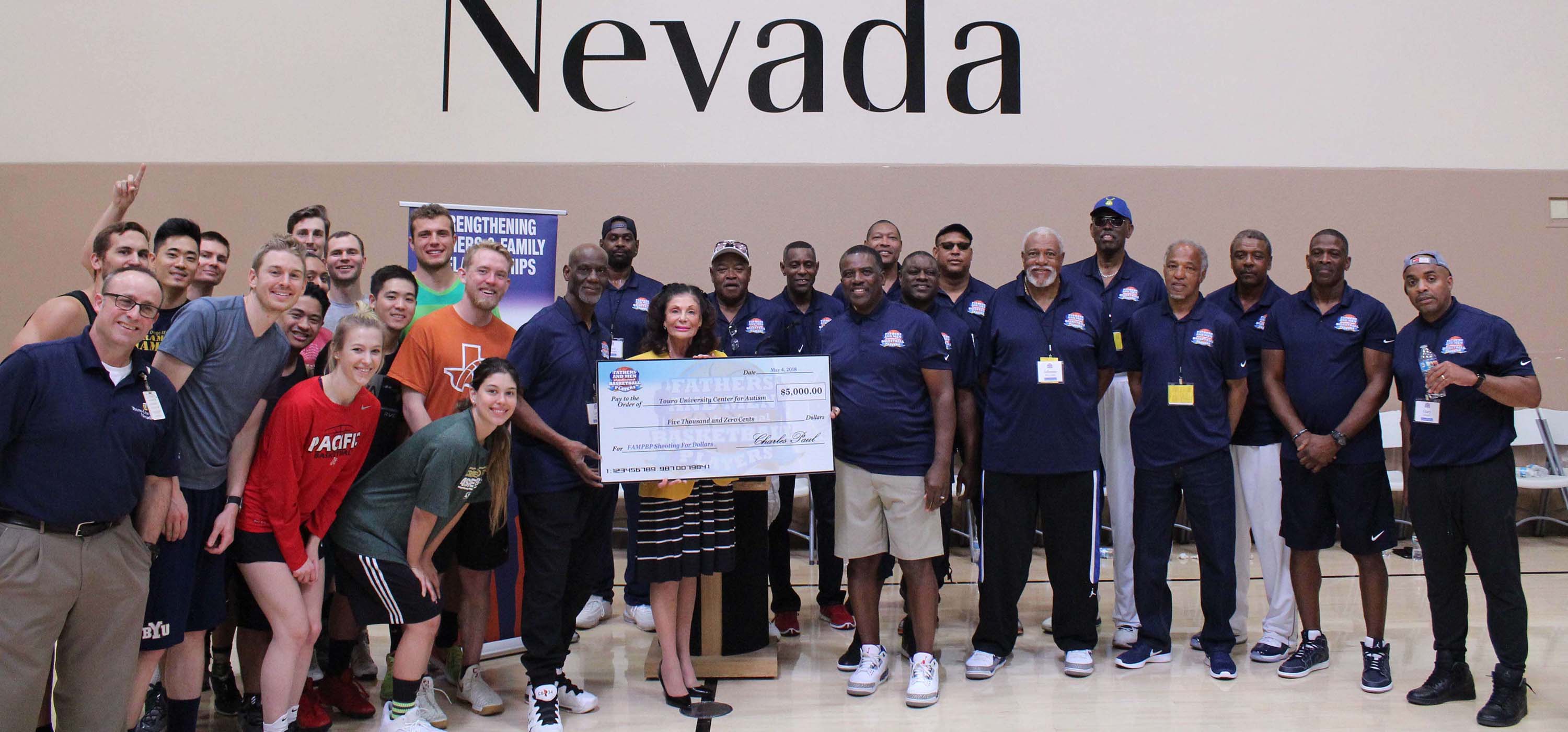 The fathers of NBA greats on the basketball court with the Touro Nevada team.