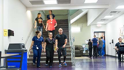 Students walking down the stairs at Touro Nevada.
