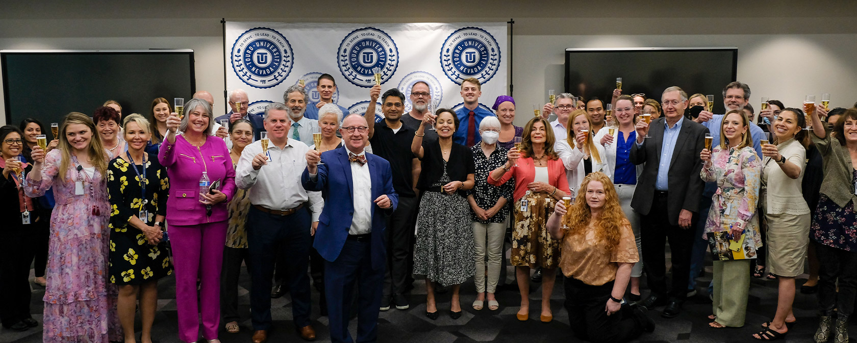 Dr. Gilliar and the members of the Touro team celebrate with a toast