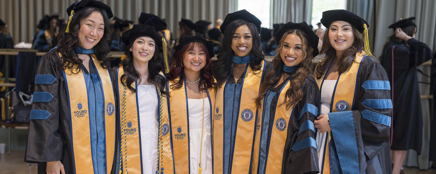 Graduates of the College of Health and Human Services take a group photo in their regalia at the commencement ceremony.