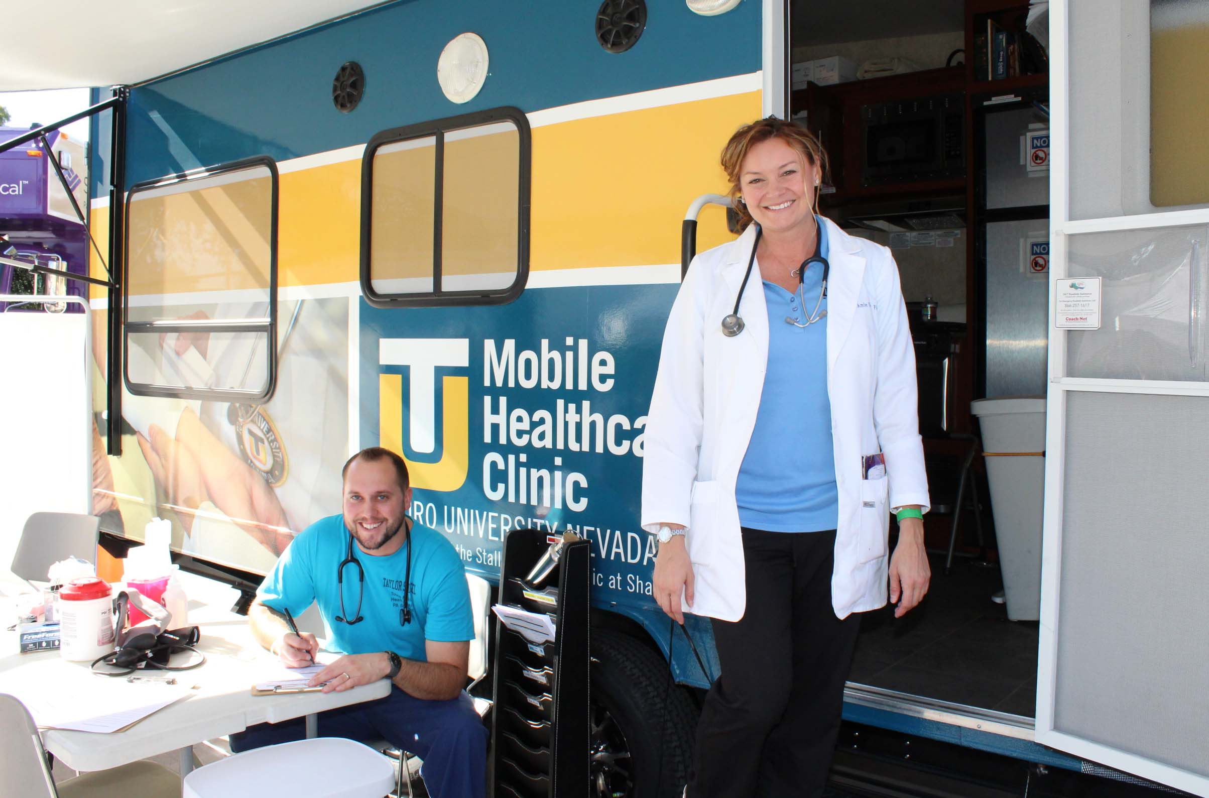 Students from the Physician Assistant Studies program outside of the mobile healthcare clinic.
