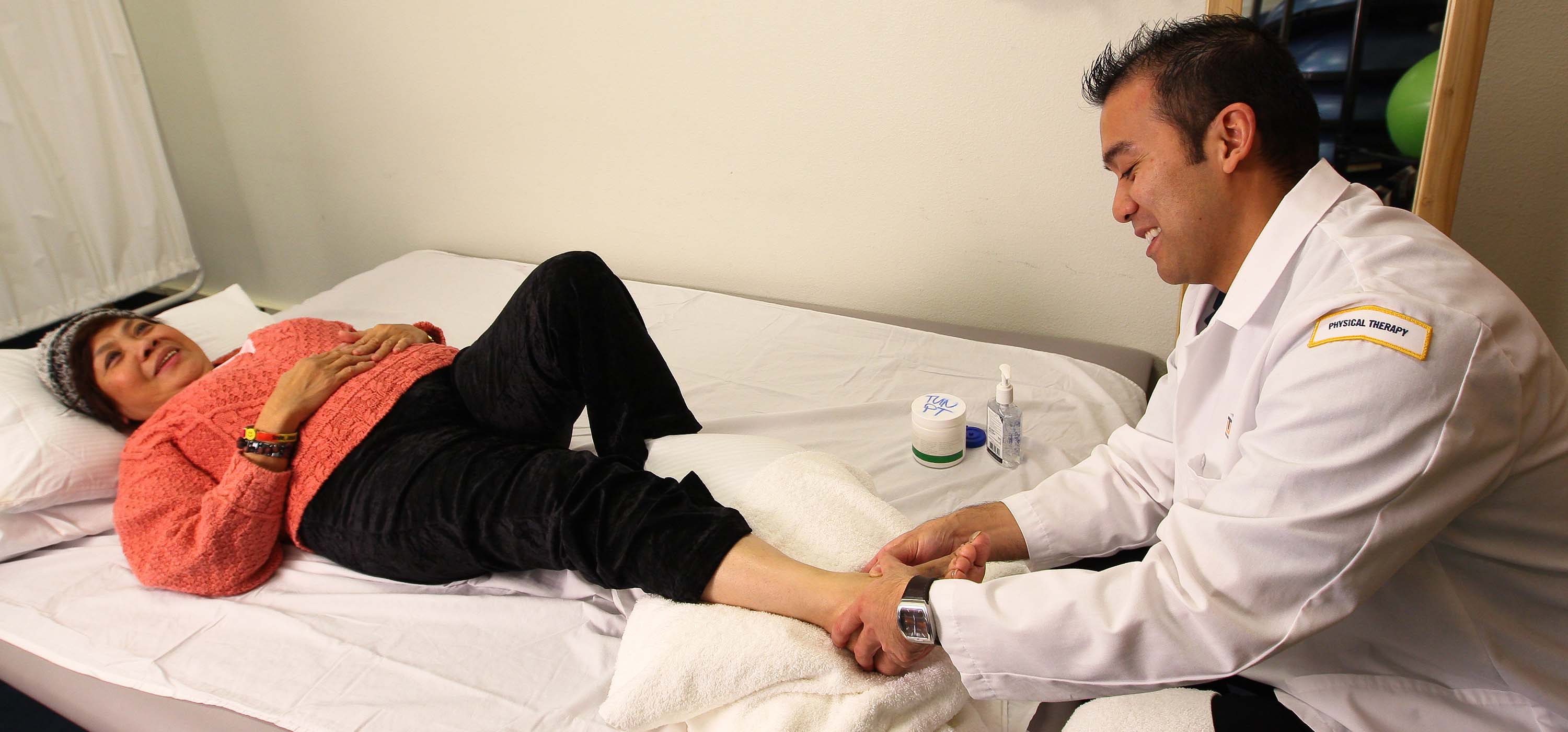 A physical therapist and a patient.