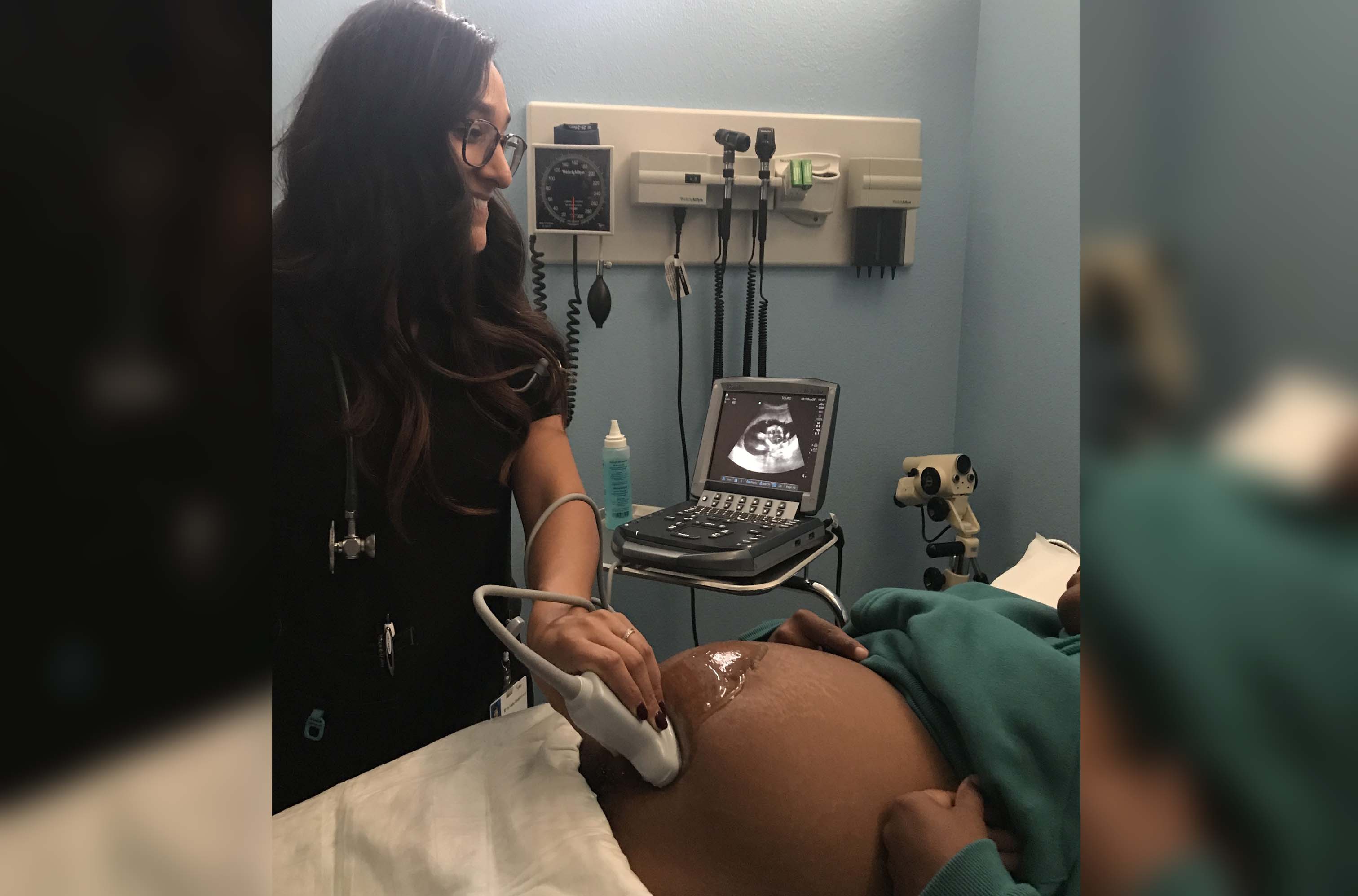 Nyla Khwaja performing an ultrasound on a a patient.